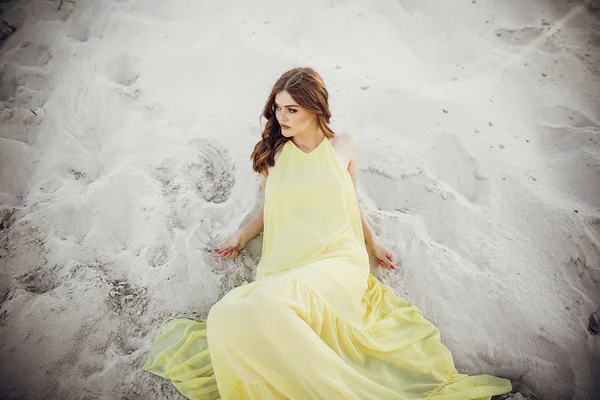 Beautiful Girl Yellow Dress Windy Hair Lying Sandy Beach — Stock Photo, Image