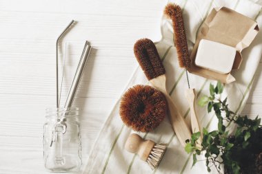 eco natural coconut soap and brushes for washing dishes, metal straws, eco friendly flat lay. sustainable lifestyle concept. zero waste food cleaning. plastic free items. reuse, reduce clipart