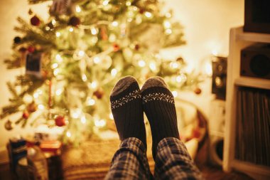 Altın güzel Noel ağacı ışıkları Festival odasında ile arka plan üzerinde eski ahşap sandalye şenlikli çorap. zaman rahatla. kış tatili rahat. sıcak atmosferik an.