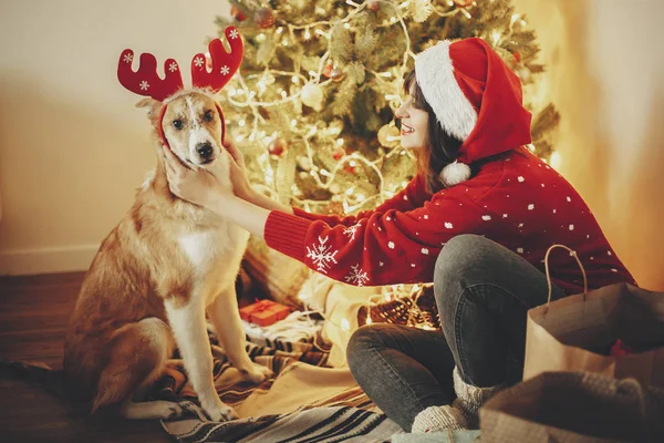 Girl Putting Cute Dog Reindeer Antlers Background Golden Beautiful Christmas — Stock Photo, Image