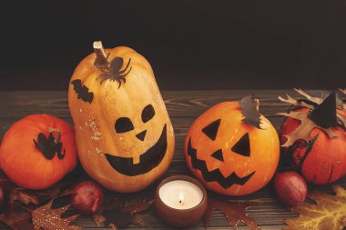 Mutlu Cadılar Bayramı kavramı. Pumpkins, mum ışığı ve ahşap arka plan üzerinde sonbahar yaprakları