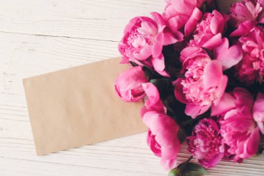 çok güzel pembe peonies boş el sanatları kartı rustik beyaz ahşap arka plan en iyi görünümde, metin için yer ile. çiçek tebrik kartı mock-up. güzel çiçekler. mutlu anneler günü kavramı