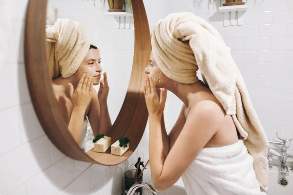 Young Happy Woman Towel Applying Organic Face Mask Looking Mirror — Stock Photo, Image