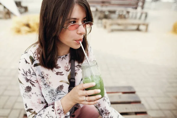 Elegante hipster boho menina beber espinafre smoothie no frasco de vidro — Fotografia de Stock