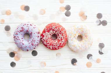 Şık beyaz masada sprinkles ile lezzetli renkli donut