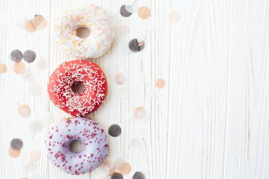 Şık beyaz masada sprinkles ile lezzetli renkli donut