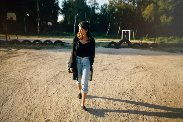 Stylish hipster girl walking in sunny street, atmospheric moment — Stock Photo, Image