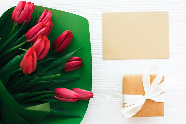 Happy mothers day. Beautiful red tulips bouquet in green paper,g