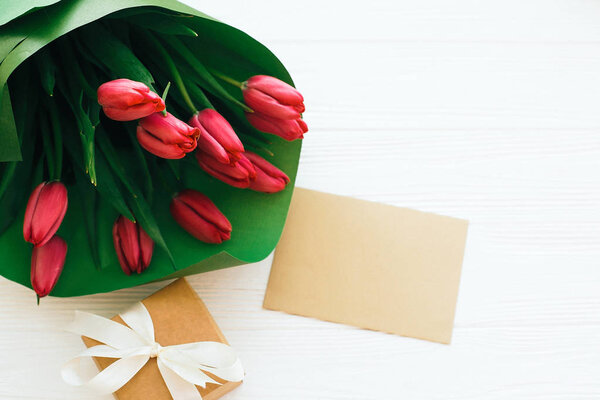 Beautiful red tulips bouquet in green paper,gift box and craft c