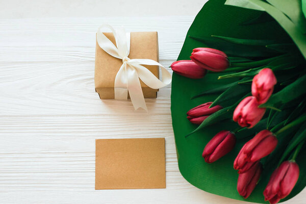 Beautiful red tulips bouquet in green paper,gift box and craft c