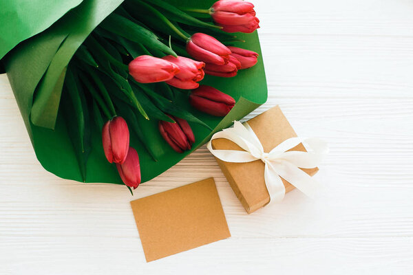 Happy mothers day. Beautiful red tulips bouquet in green paper,g