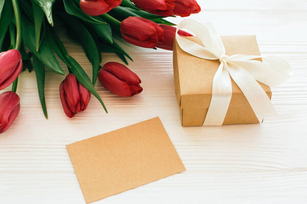 Beautiful red tulips with gift box and craft card with space for