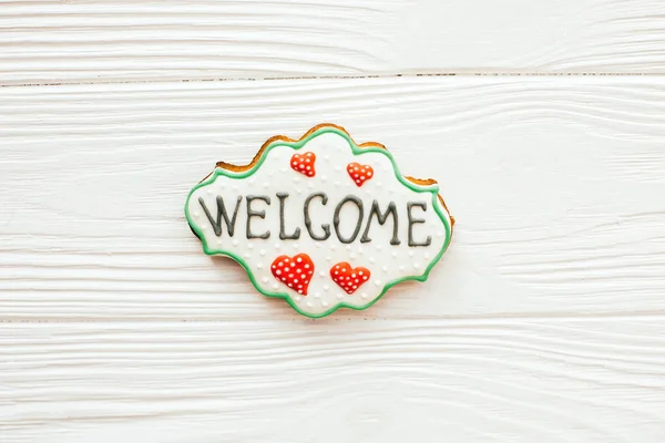 Welcome home sign cookie on white wood, flat lay with space for — Stock Photo, Image