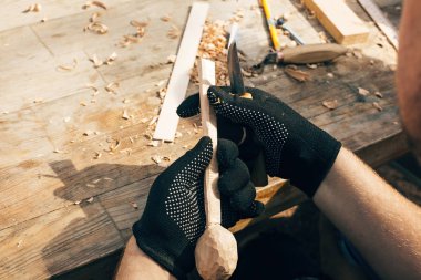 Tahta atölyesi. Eller tahtadan kaşık oyuyor, chi ile çalışıyor.