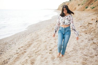 Şık hipster kız denizde sahilde çalışan ve gülümseyerek. Mutlu 