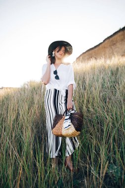 Güneşli akşam lig çim arasında poz şapka şık boho kız