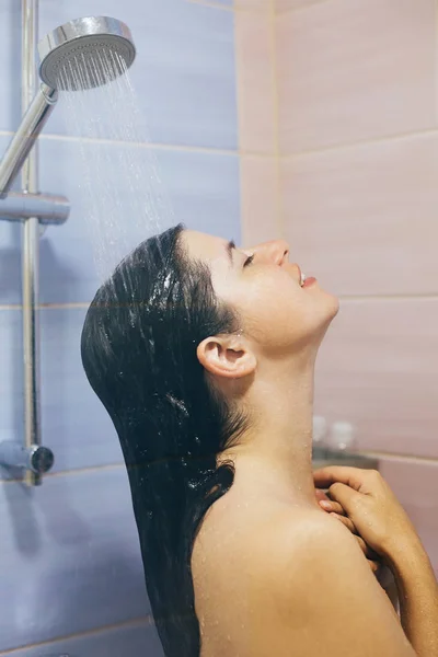 Joven mujer feliz tomando ducha caliente en casa o baño de hotel. B) — Foto de Stock