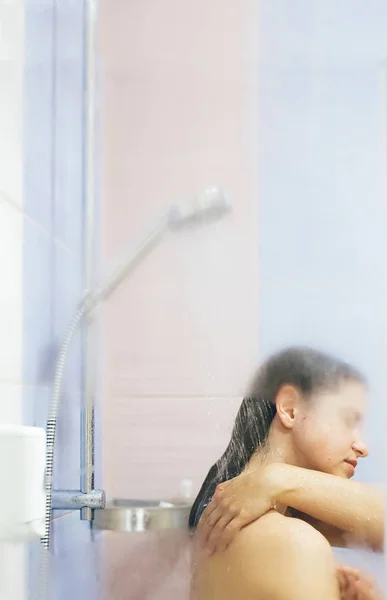 Young happy woman taking hot shower at home or hotel bathroom. S — 스톡 사진