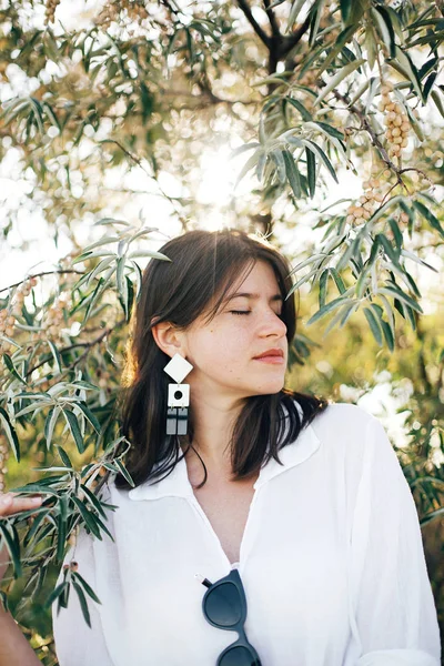 Portrait of young fashionable woman with modern earrings posing — Stock Photo, Image