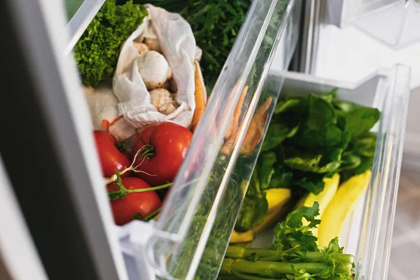 Zero waste grocery in fridge. Fresh vegetables in opened drawer