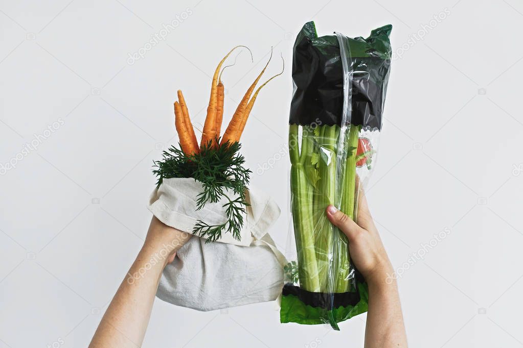 Hands holding reusable eco friendly bag with fresh carrots again