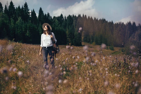Hipster meisje met rugzak reizen in zonnige bergen, wandelen — Stockfoto