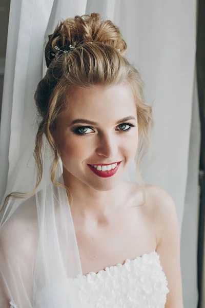 Stylish happy bride smile and posing in soft light near window — Stok Foto