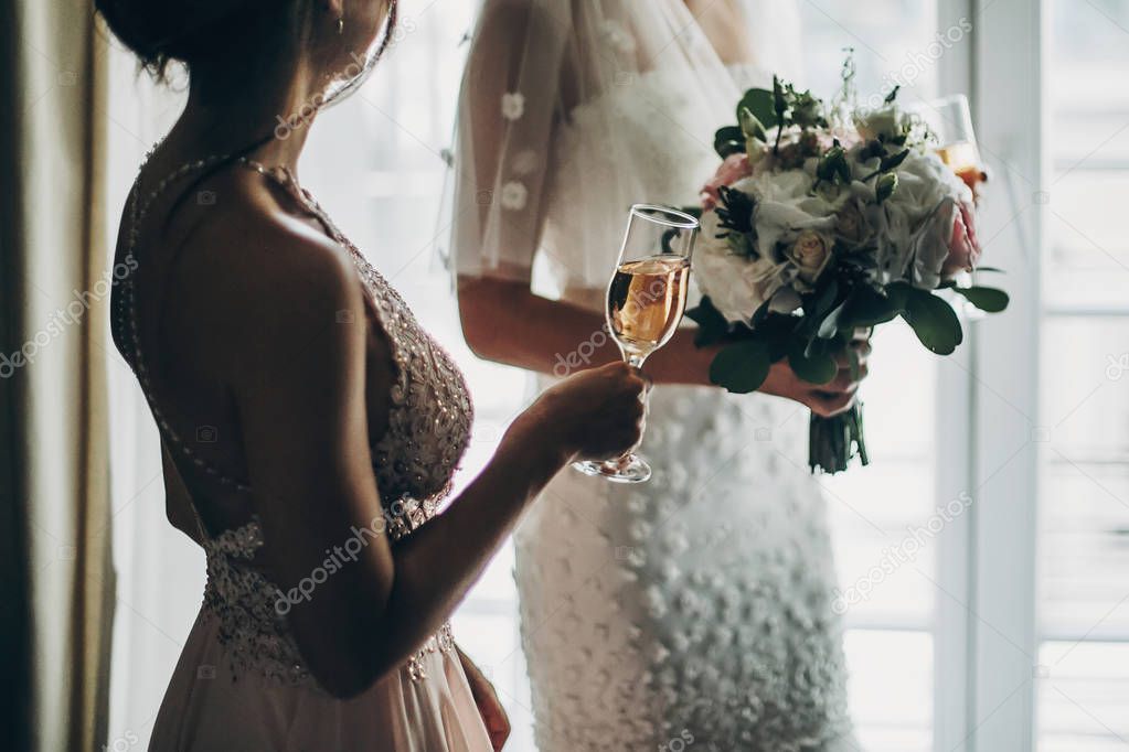Cropped view of stylish bride holding modern wedding bouquet and