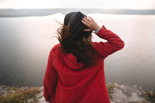 Reisenden Mädchen mit windigen Haaren mit Hut und Blick auf den Abend — Stockfoto