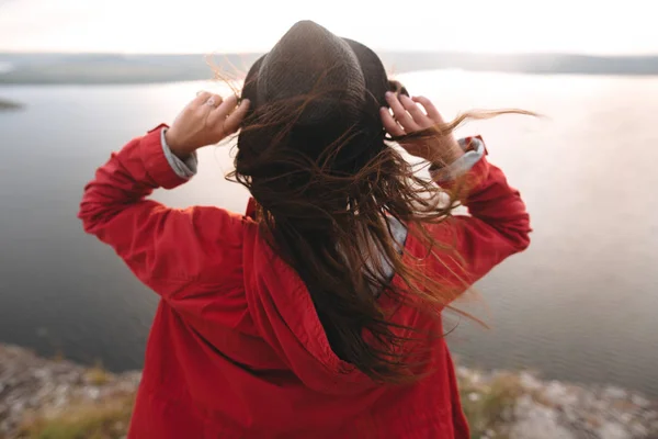 Мандрівник дівчина в капелюсі і з вітряним волоссям, що стоїть на вершині каменю — стокове фото