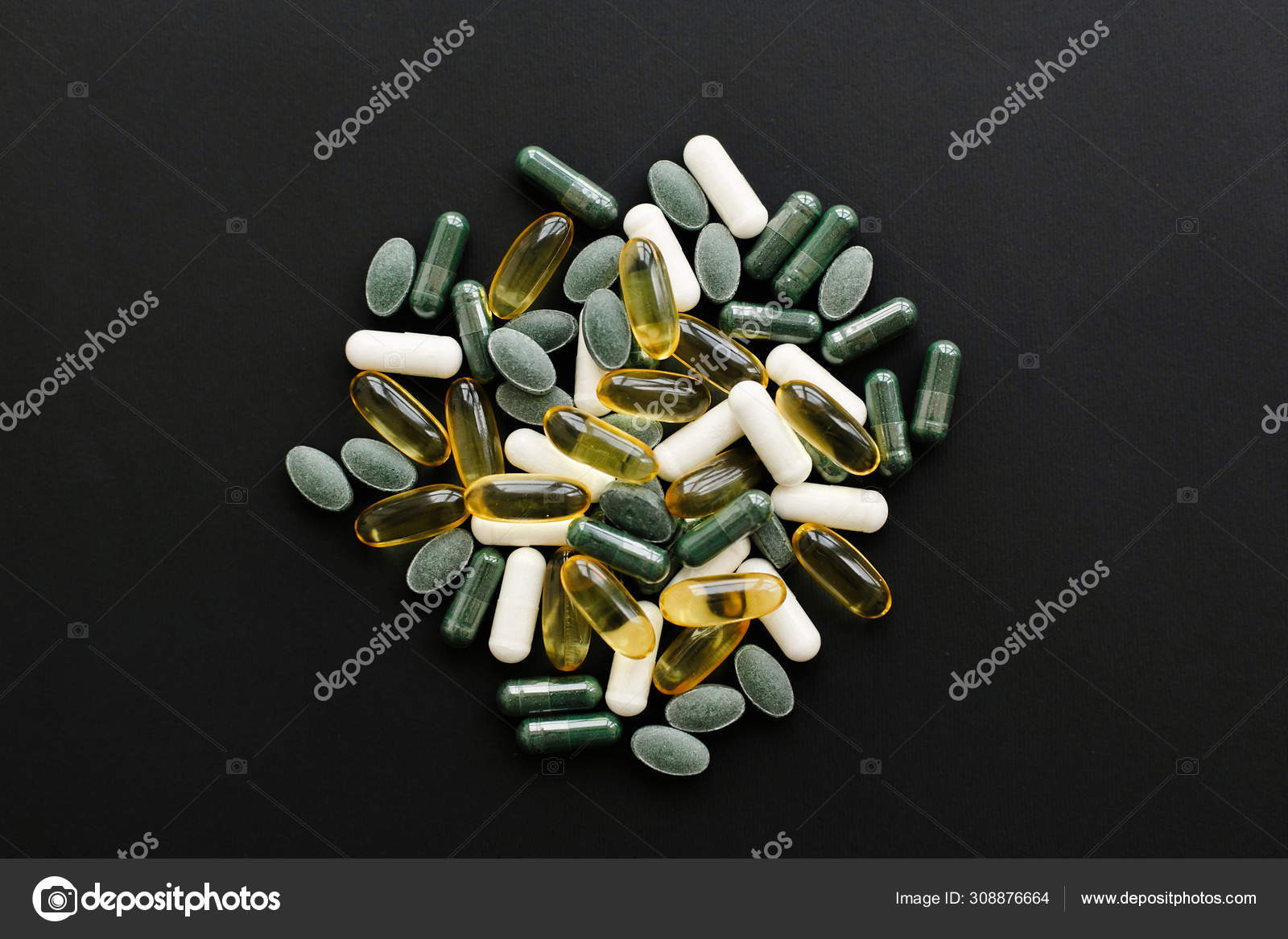 Omega 3, spirulina, chlorophyll,magnesium capsules on black dar Stock