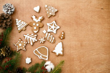 Noel kurabiyeleri ve köknar dalları tahtayla sınırlıdır. Mevsimin tebrik kartı ve mesaj için yeri var. Lezzetli ev yapımı zencefilli kek ağacı, ren geyiği, yıldız kurabiyeleri. İyi tatiller.!