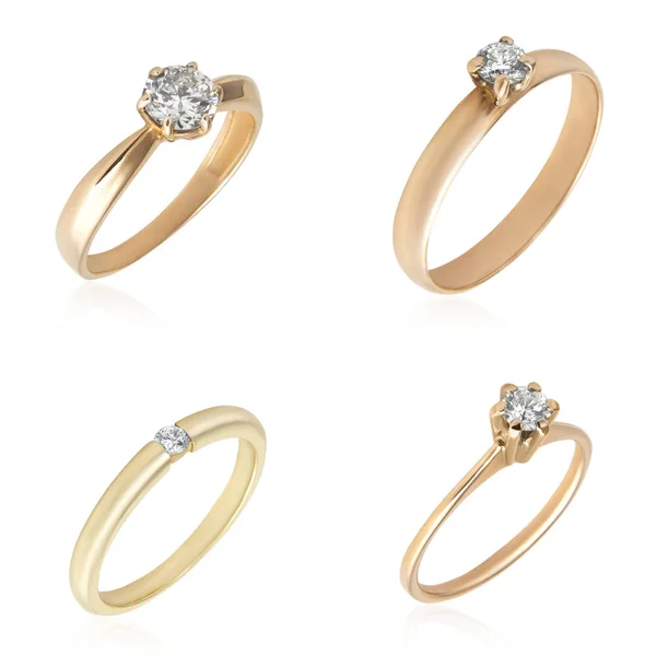 Set di anelli di diamanti d'oro isolati su bianco Foto Stock