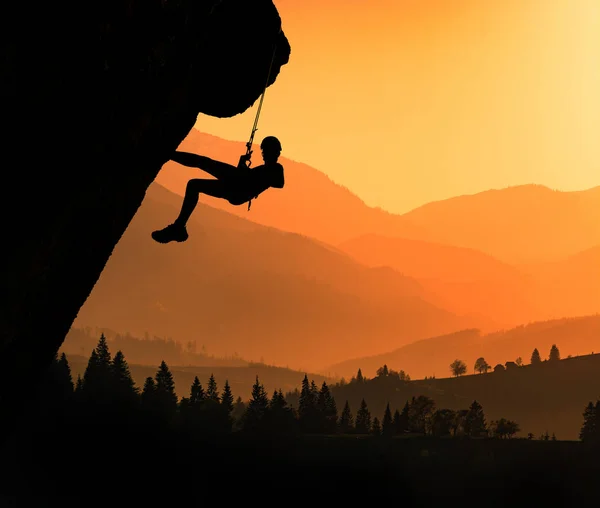 Climber silhouette against carpathian mountains in a beautiful light of sunset. Ukraine, Europe.