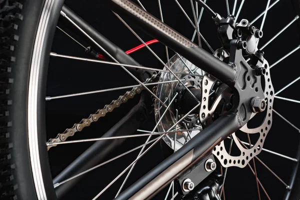 Mountain bicycle photography in studio. Bike wheel with disc brakes and chain. Bike part.