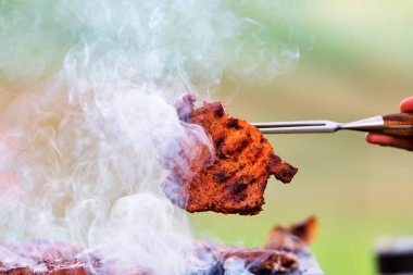 Duman ve ateş ile sıcak bir ızgara barbekü domuz eti biftek et