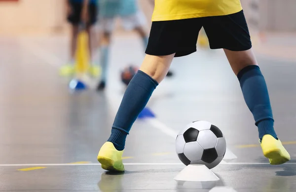 Indoor soccer players training with balls. Indoor soccer sports hall. Football futsal player, ball, futsal floor. Sports background. Futsal league. Indoor football players with classic soccer ball.