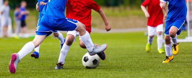 Genç genç futbol maçı. Çalışan ve futbol topu tekmeleme oyuncular