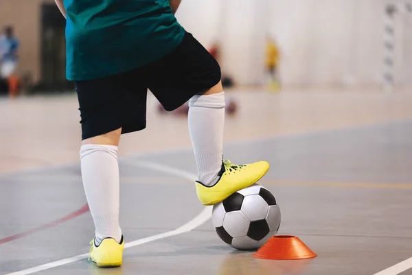 Indoor soccer player training with balls. Indoor soccer sports hall. Football futsal player, ball, futsal floor. Sports background. Futsal league. Indoor football players with classic soccer ball.