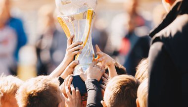 Close-up of Kids Sports Team with Trophy. Boys Celebrating Sports Achievement. Team Sports Champions. Soccer Football Winning Victory Celebration Moment clipart