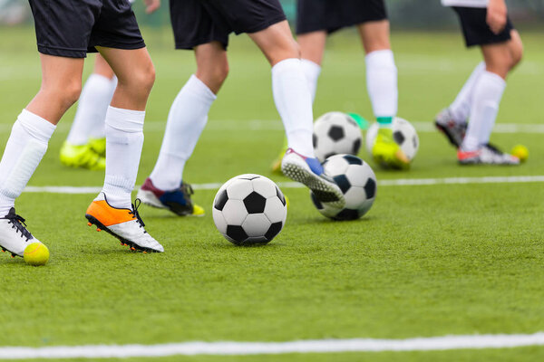 Football Soccer Training Drills: Young Players Practicing Soccer Run with Ball. Soccer Training on Fresh Grass Field