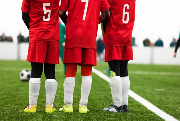 Junior Soccer Players Standing in a Wall. Free Kick Situation During Football Match. Players Wearing Red Soccer Jersey Shirts with Numbers on Back. Soccer Tournament Game