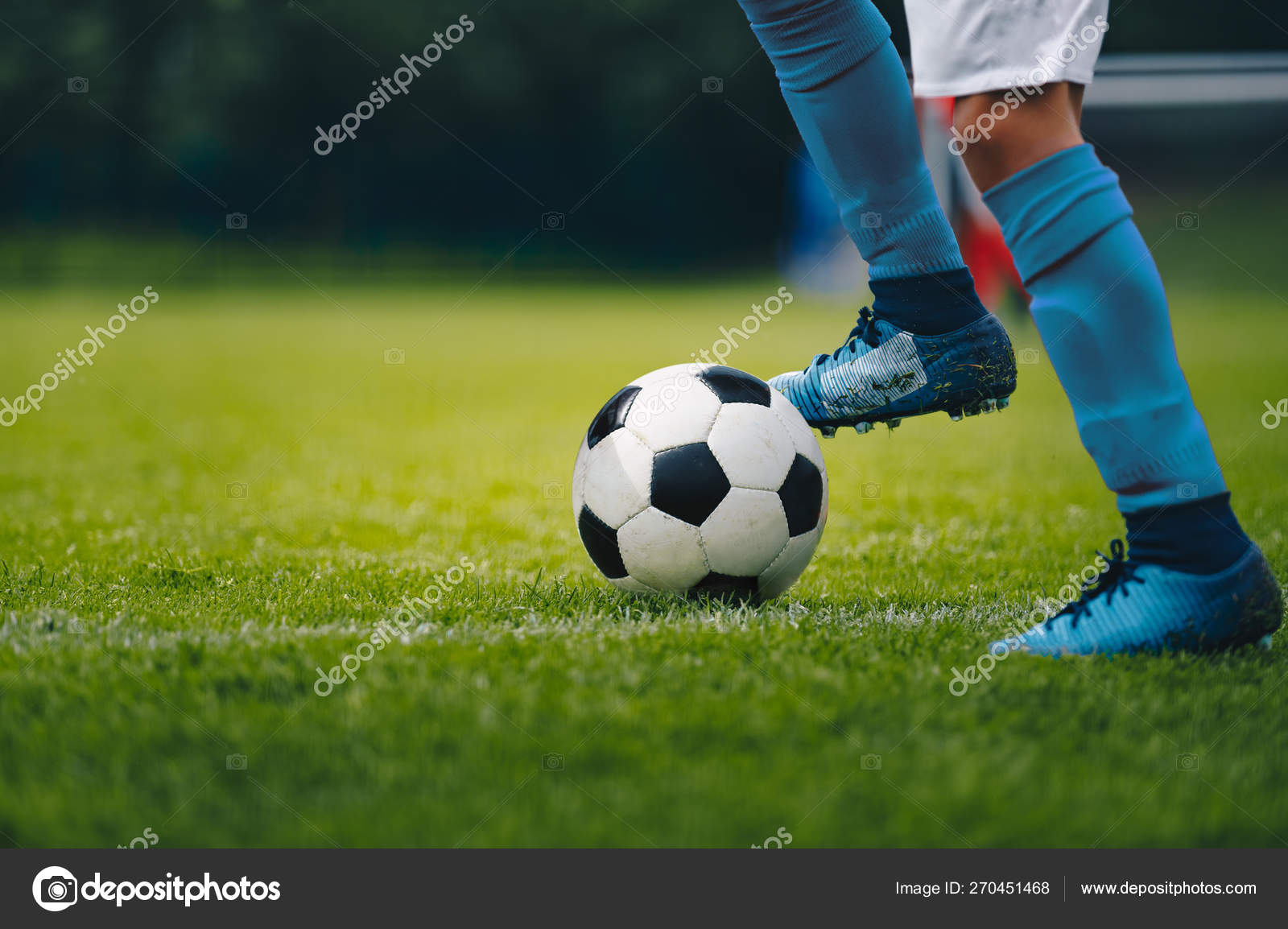 Close Up Of Legs And Feet Of Football Player In Blue Socks And Shoes Running And Dribbling With The Ball Soccer Player Running After The Ball Sports Venue In The Background Close Up Of Legs And Feet Of Football Player In Blue Socks And Shoes Running And Dribbling With The Ball Soccer Player Running After The Ball Sports Venue In The Background
