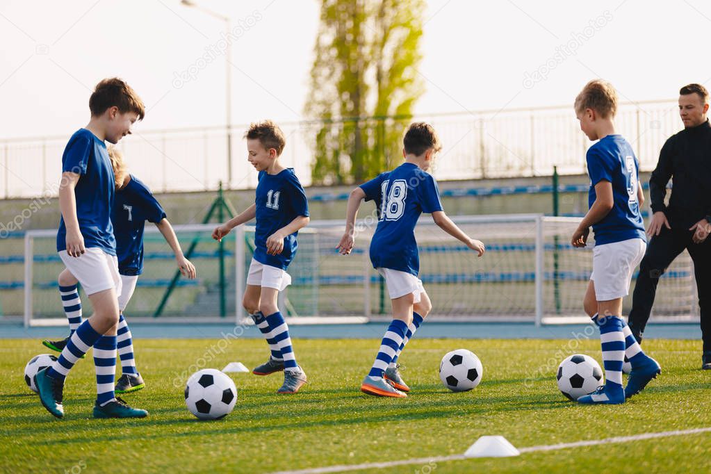 Young Boys in Sports Club on Soccer Football Training. Kids Enhance Soccer Skills on Natural Turf Grass Pitch. Football Practice Session for Children Youth Team of Professional School Soccer Club