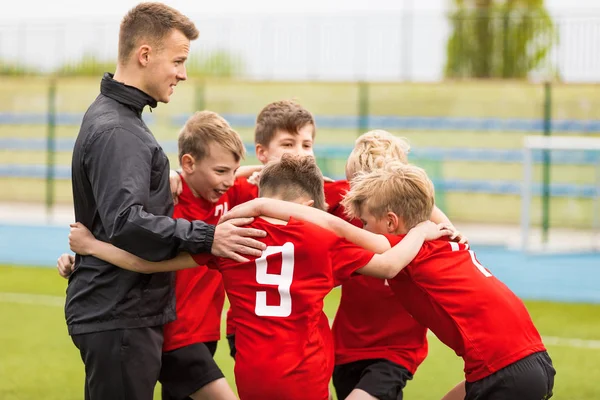 Treinando Esportes Juvenis. Kids Soccer Football Team Huddle com o treinador. Crianças jogam esportes jogo. Sporty Team United Pronto para Jogar. Esportes da juventude para crianças. meninos em esportes Jersey camisas vermelhas — Fotografia de Stock