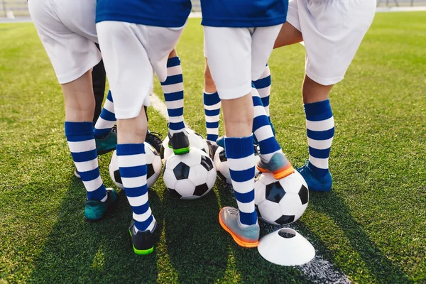 Children Football Team Players. Sports Boys in a School Team. Kids Huddling in a Team on Tournament Competition. Players Gathering Together in a Circle. Kids in Soccer Sportswear