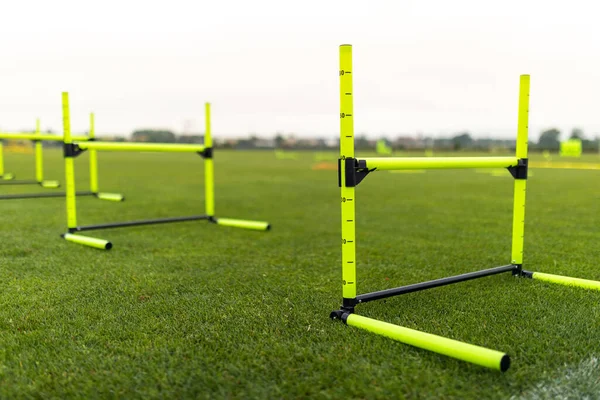 Speed Training Hurdles. Yellow Durable Agility Hurdles. Sport Training Equipment on Grass Pitch
