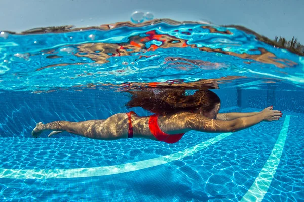 Portrait of plump young woman relaxing in swimming pool - a