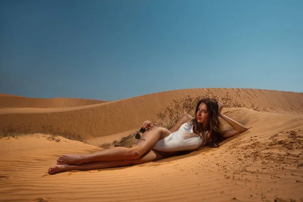 閉じる側ビューのタンセクシー女性でA白い水着嘘砂の上にリラックスビーチ — ストック写真