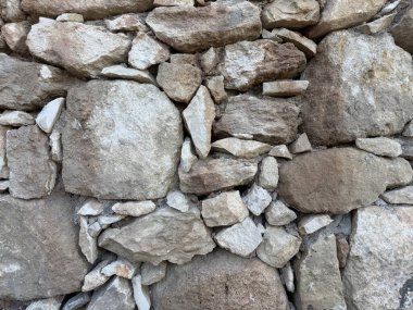 Taş duvar fotoğrafı, dokulu arka plan. Kırsal taştan bir duvara yakın çekim.